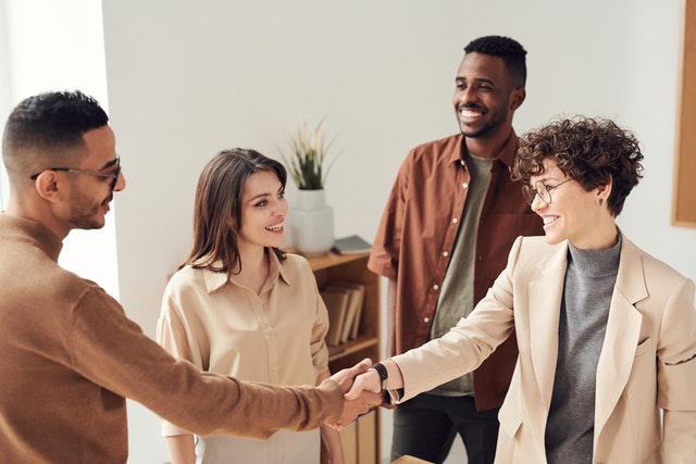 a group of people meeting and shaking hands